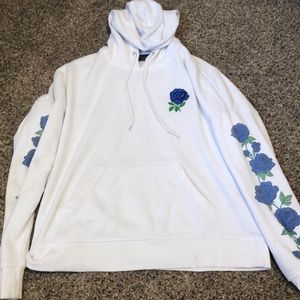 A hoodie with blue rose accents